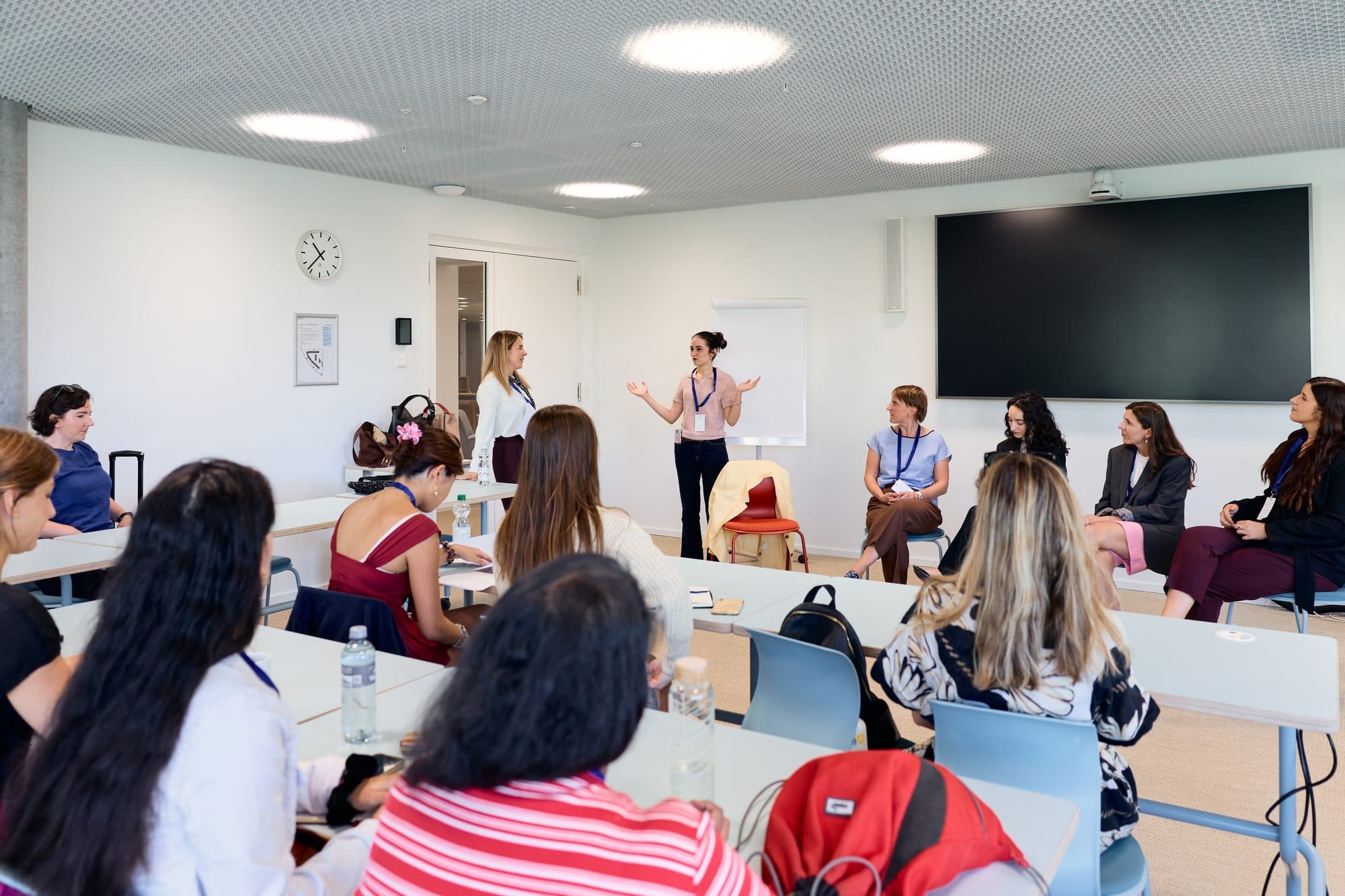 A speaker addressing a seated group during a workshop session at the Health VC Summit